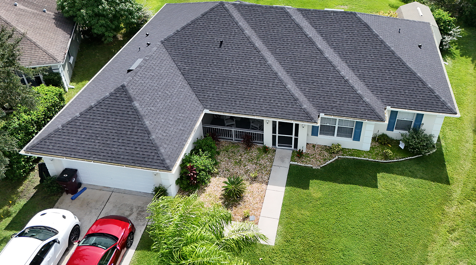 drone shot of a single family residential home with a gray shingle roof